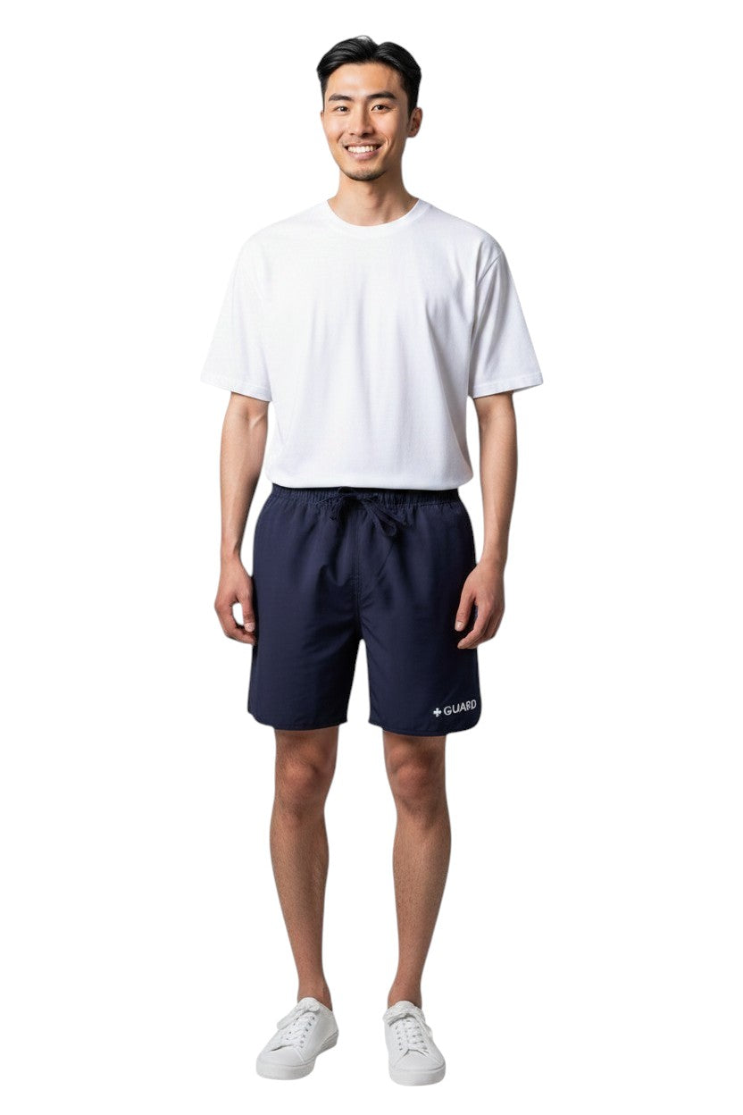 The Lifeguard Store Men's navy blue polyester swim shorts with liner, 5" inseam, drawstring waist, and GUARD logo.