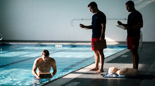 Lifeguard certification skills test with a timed brick retrieval assessed by an instructor