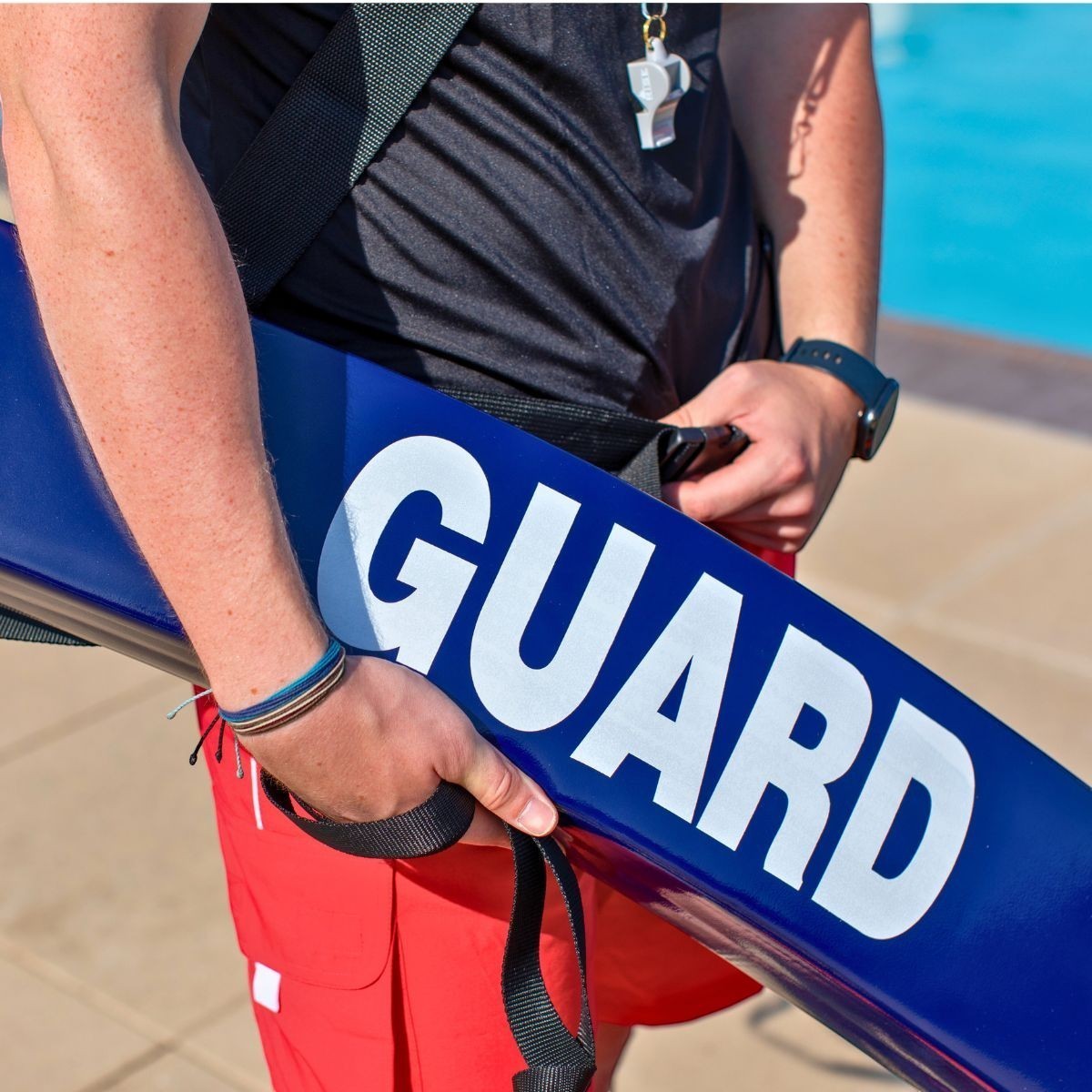 The Lifeguard Store 50" blue vinyl rescue tube with white "GUARD" lettering, featuring a NBR foam core and heavy-duty towline.