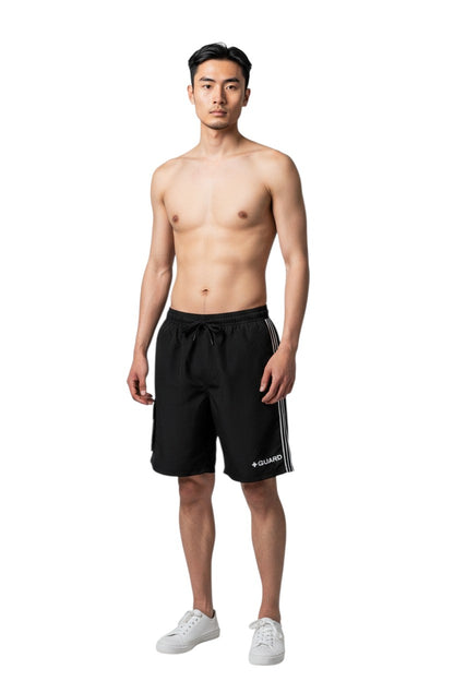The Lifeguard Store black polyester board shorts with liner, drawstring waist, cargo pocket, and side stripe detail. Features UPF30+ protection.