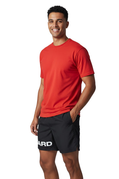 The Lifeguard Store black 4-way stretch polyester lifeguard deck shorts with "GUARD" printed on the leg.