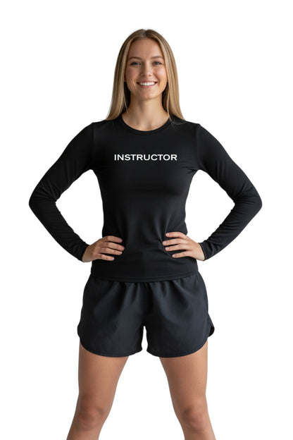The Lifeguard Store black long sleeve rashguard with "INSTRUCTOR" printed on the chest. Made of poly-spandex blend.