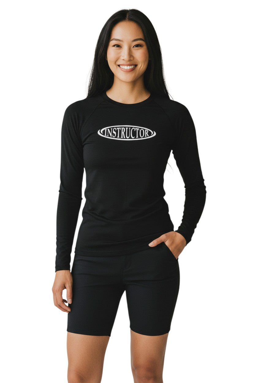The Lifeguard Store black long sleeve rashguard with "INSTRUCTOR" graphic on chest. Made of poly-spandex blend.