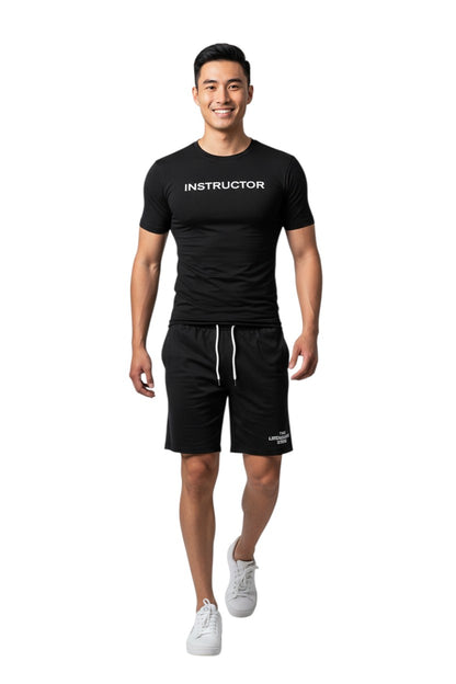 The Lifeguard Store black short sleeve rashguard with "INSTRUCTOR" printed on the chest. Made of polyester and spandex.