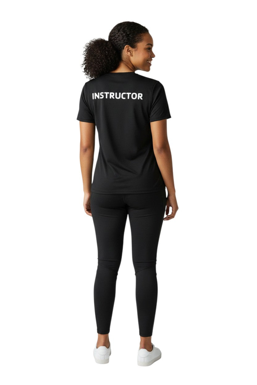The Lifeguard Store black short sleeve rashguard with white "INSTRUCTOR" text on back. Made of 91% polyester/9% spandex.