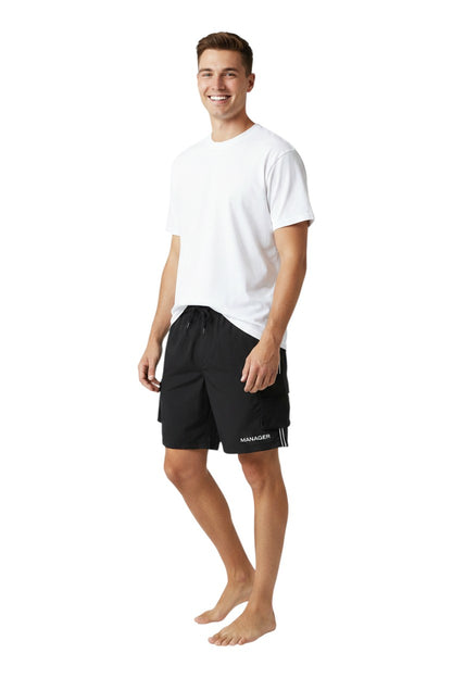 The Lifeguard Store black polyester board shorts with liner, elastic waistband, drawstring, and cargo pocket. "MANAGER" printed on the lower right leg.