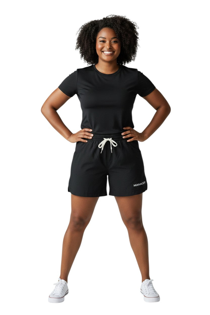 The Lifeguard Store black polyester roll shorts with elastic waistband, drawstring, and "MANAGER" text.
