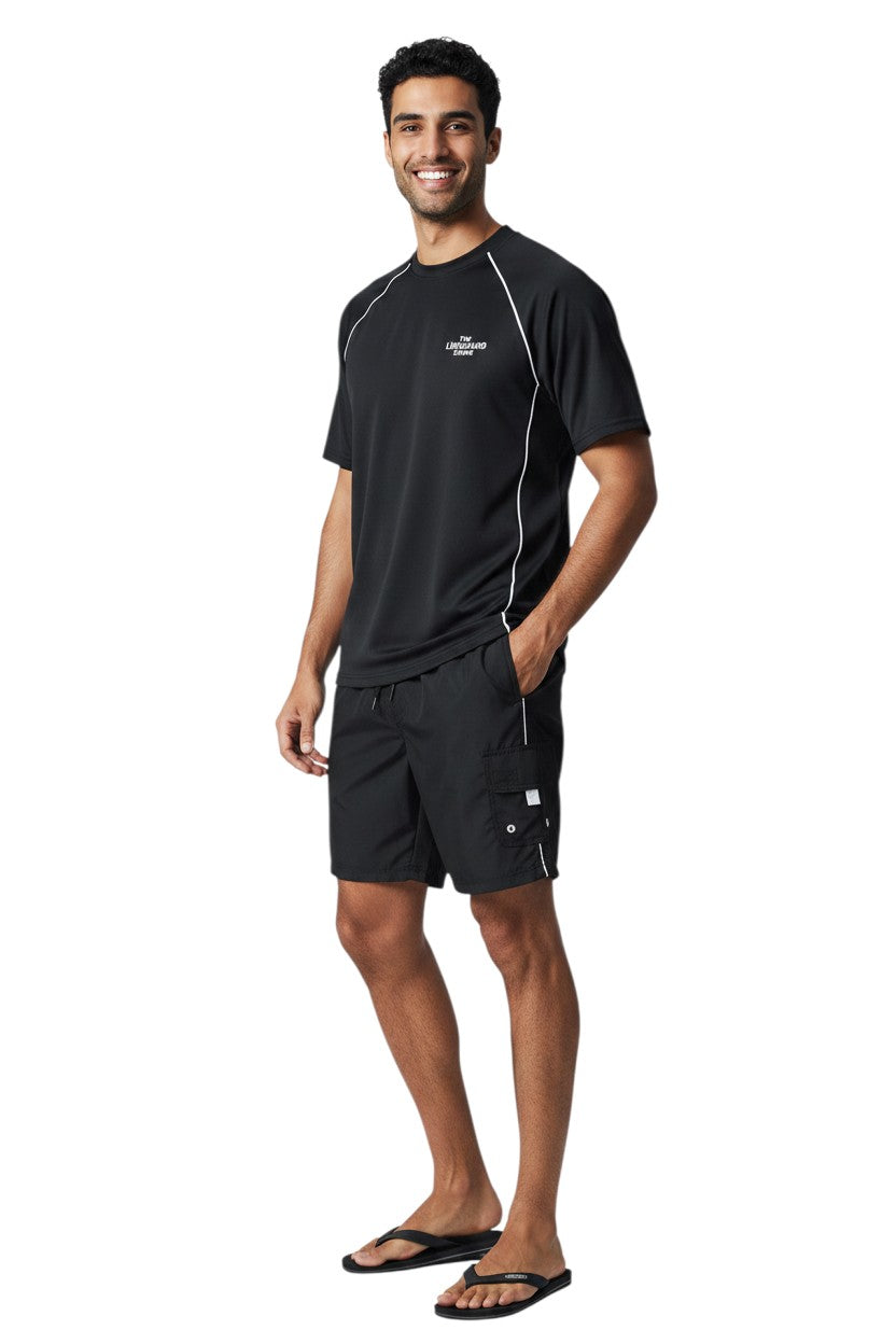 The Lifeguard Store black polyester board shorts with white trim and a velcro pocket. Features elastic waistband and drawstring.
