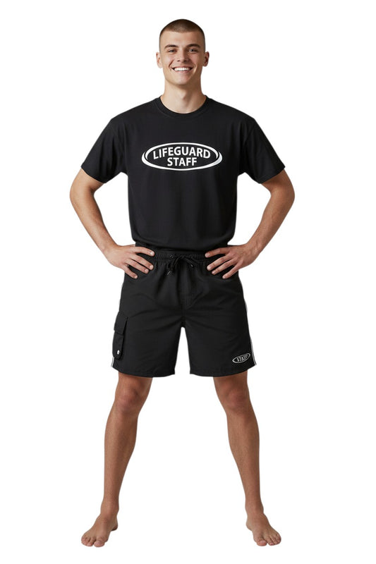 The Lifeguard Store black polyester board shorts with elastic waistband, drawstring, cargo pocket, and staff logo. 7" inseam.