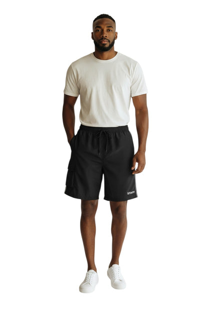 The Lifeguard Store black polyester staff board shorts with liner, elastic waistband, drawstring, and cargo pocket.