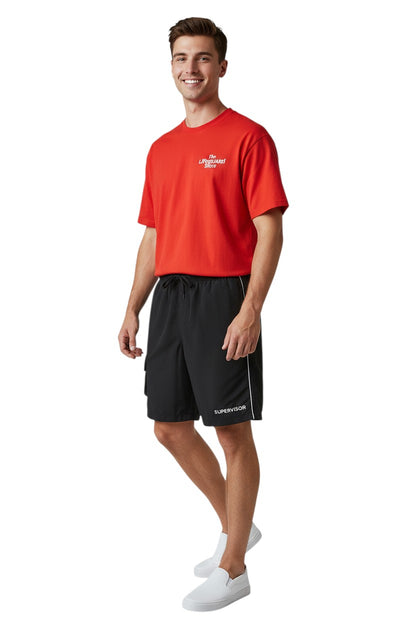 The Lifeguard Store black polyester supervisor board shorts with drawstring, cargo pocket, and white stripe detail.
