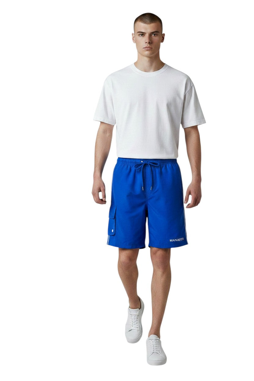 The Lifeguard Store blue polyester board shorts with white drawstring, side cargo pocket, and white piping. Features UPF30+ protection.