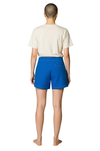 The Lifeguard Store blue polyester-spandex flex shorts with white contrast stitching and drawstring waist.