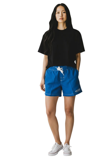 The Lifeguard Store blue polyester-spandex blend board shorts with white drawstring and GUARD logo.