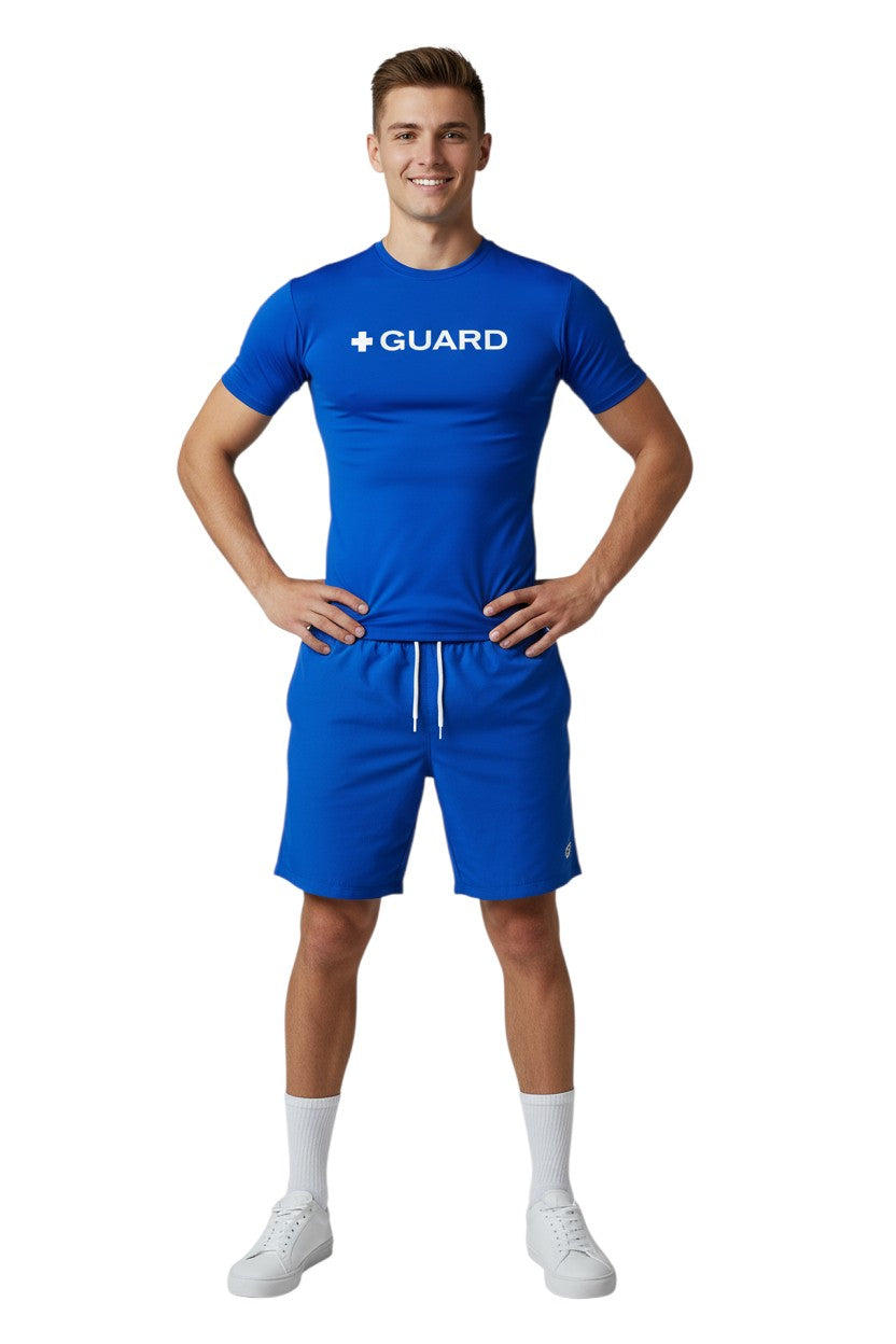 The Lifeguard Store blue short sleeve rashguard with white + GUARD text on chest. Polyester-spandex blend.