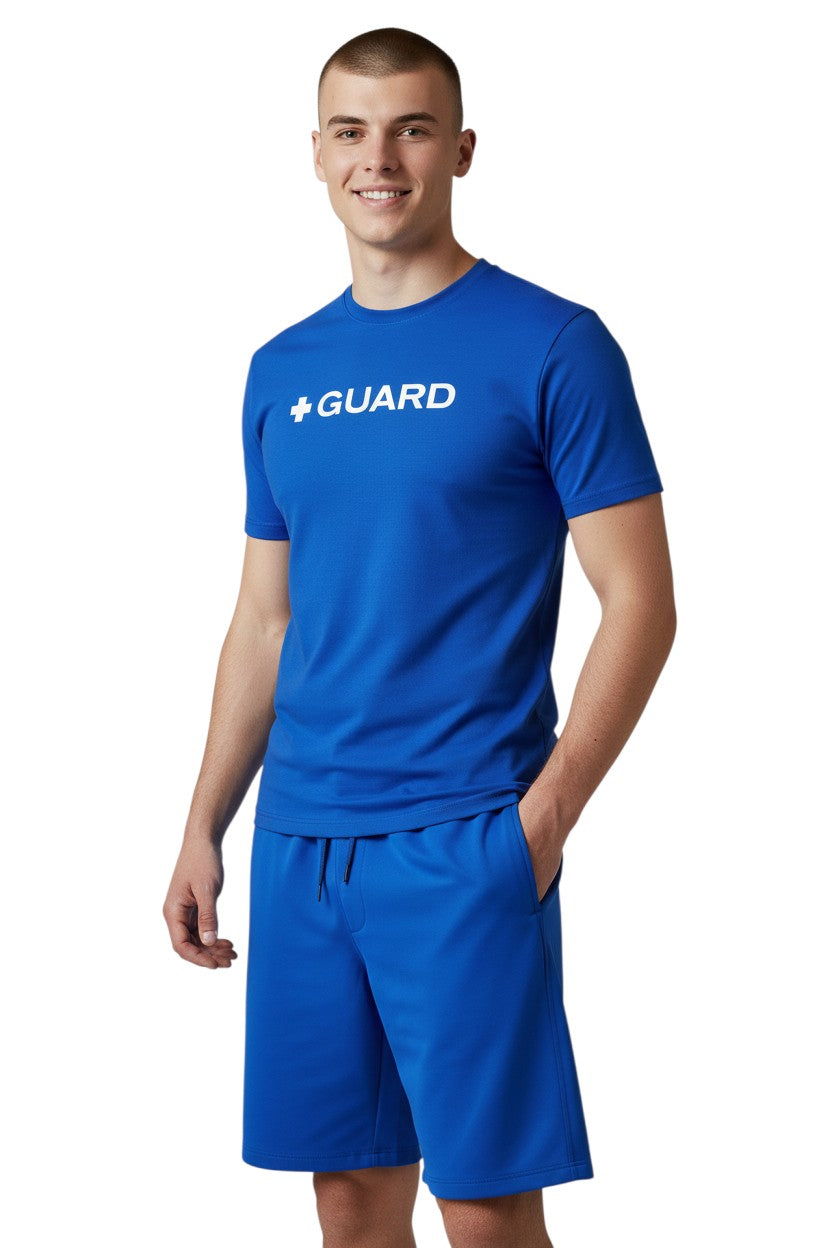 The Lifeguard Store blue short sleeve crewneck rashguard with white + GUARD text on chest. Polyester/spandex blend.