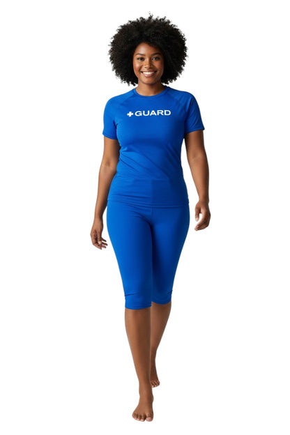 The Lifeguard Store blue short sleeve crewneck rashguard with white + GUARD text on chest. Polyester/spandex blend.
