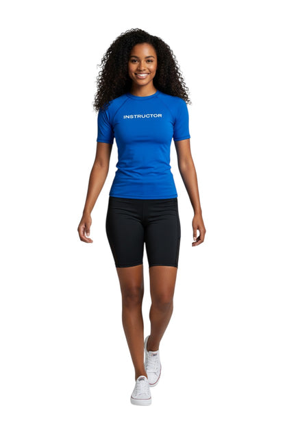 The Lifeguard Store blue short sleeve rashguard with "INSTRUCTOR" printed on the chest. Made of 91% polyester and 9% spandex.