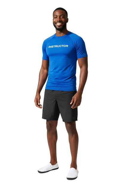 The Lifeguard Store blue short sleeve rashguard with white "INSTRUCTOR" text. Made of 91% polyester and 9% spandex.