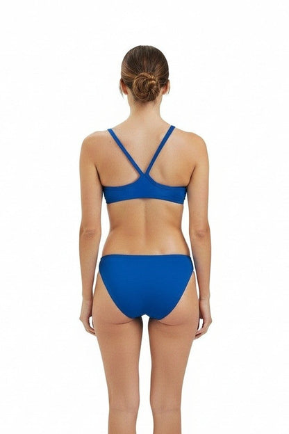 The Lifeguard Store blue RISE Guard poly bikini two-piece swimsuit viewed from the back on a model