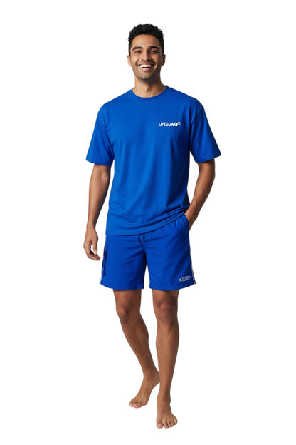 The Lifeguard Store blue polyester board shorts with elastic waistband, drawstring, side cargo pocket, and staff logo.