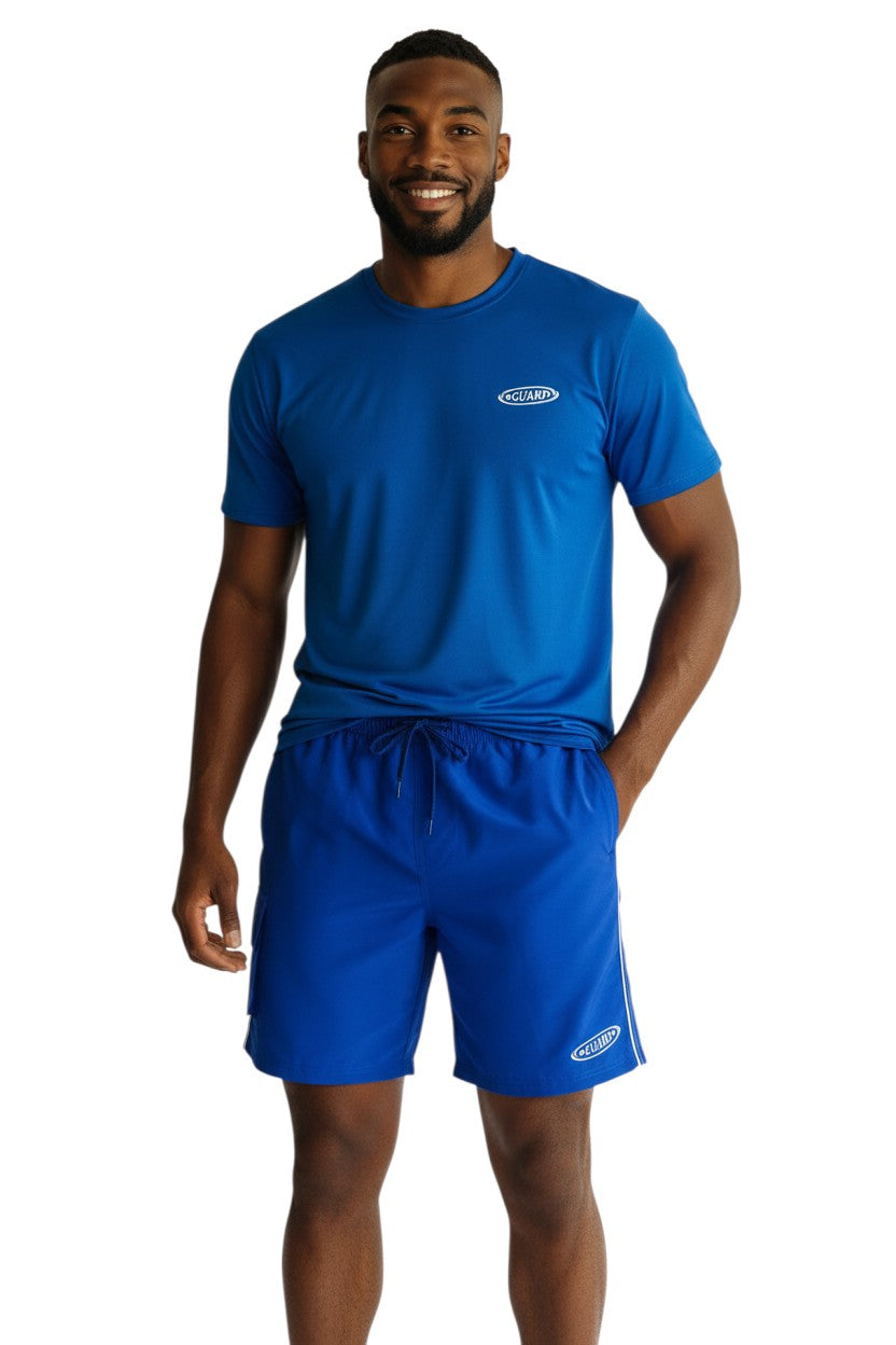 The Lifeguard Store blue polyester board shorts with elastic waistband, drawstring, and side velcro pocket. 7" inseam.