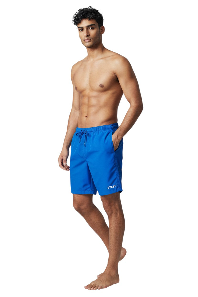 The Lifeguard Store blue polyester board shorts with liner, elastic waistband, drawstring, cargo pocket, and STAFF logo.