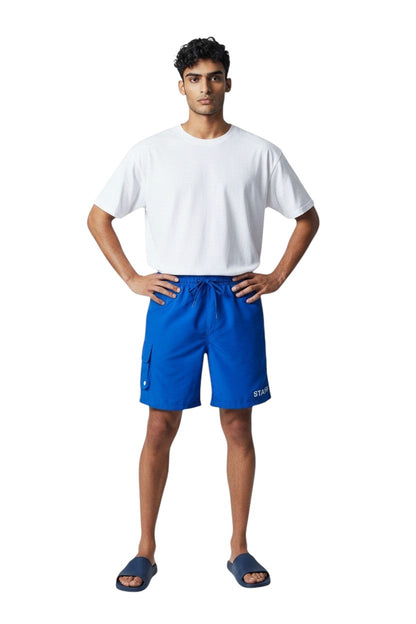 The Lifeguard Store blue polyester board shorts with liner, elastic waistband, drawstring, and cargo pocket. Features UPF30+ protection.