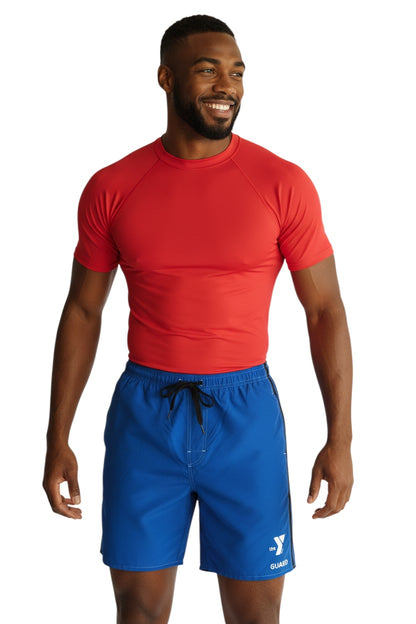 The Lifeguard Store blue polyester board shorts with black side stripes and YMCA Guard logo. Elastic waistband, drawstring, and side pocket.
