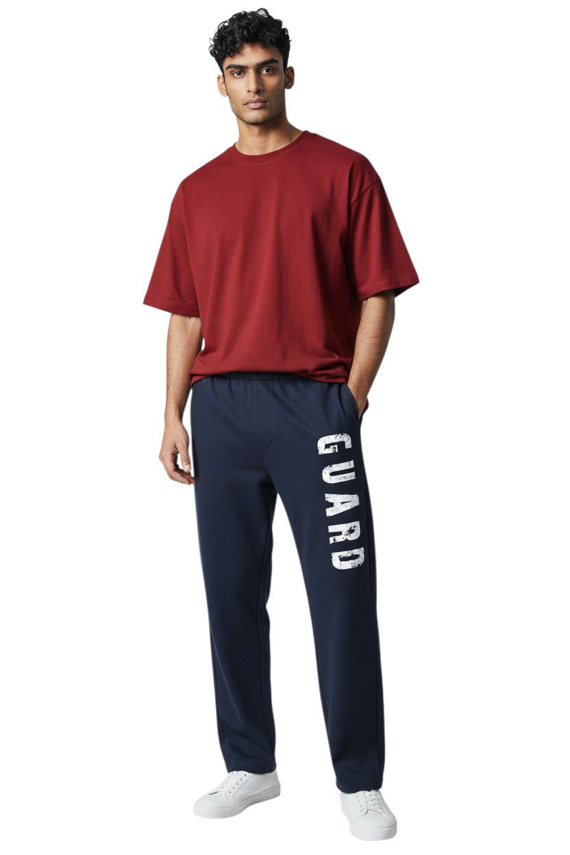 The Lifeguard Store RISE Guard Fleece Sweatpants in navy blue with white "GUARD" logo down the leg. 50% cotton, 50% polyester.