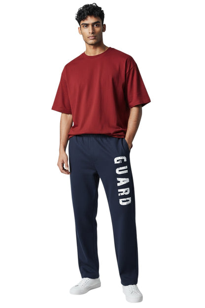 The Lifeguard Store RISE Guard Fleece Sweatpants in navy blue with white "GUARD" logo down the leg. 50% cotton, 50% polyester.