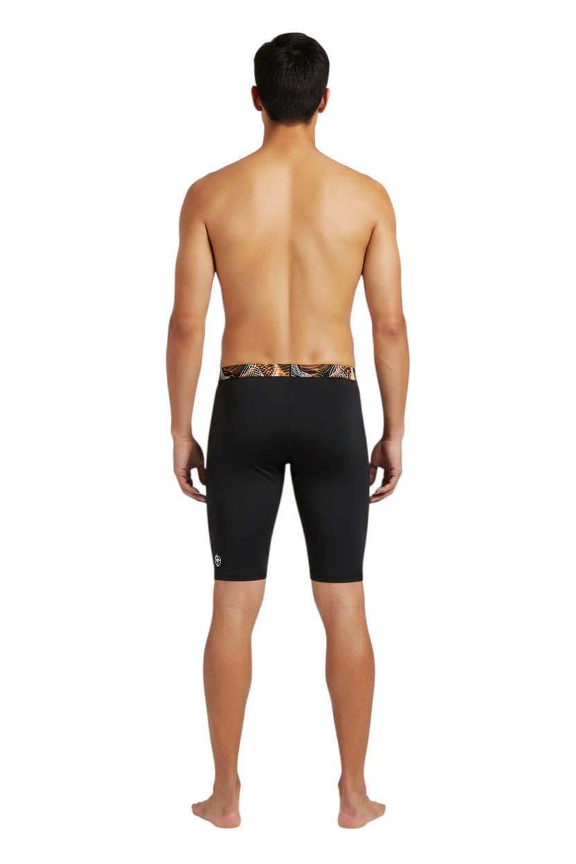 The Lifeguard Store RISE Sandies Helix Poly Jammer swimsuit with black body and abstract orange and white waistband. Made of 91% Polyester/9% Spandex.