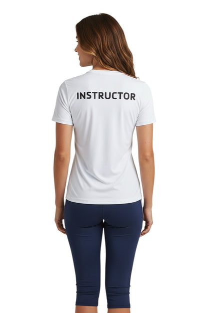 The Lifeguard Store white short-sleeve rashguard with "INSTRUCTOR" printed on the back. Made of polyester and spandex for comfort and UPF 50+ protection.