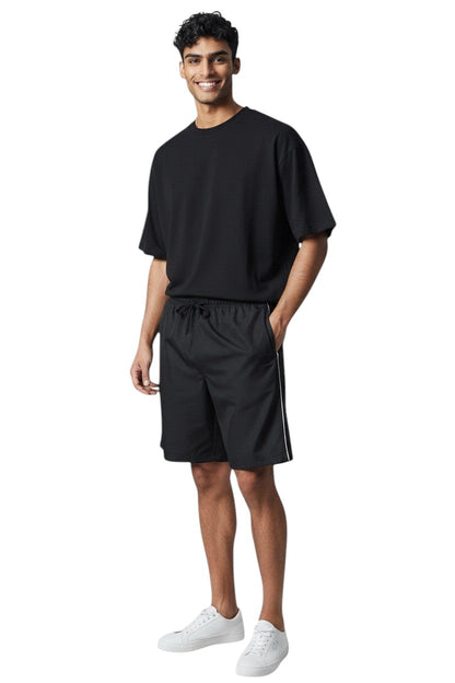 The Lifeguard Store Kiefer Solid Board Shorts in black polyester with white piping and drawstring.
