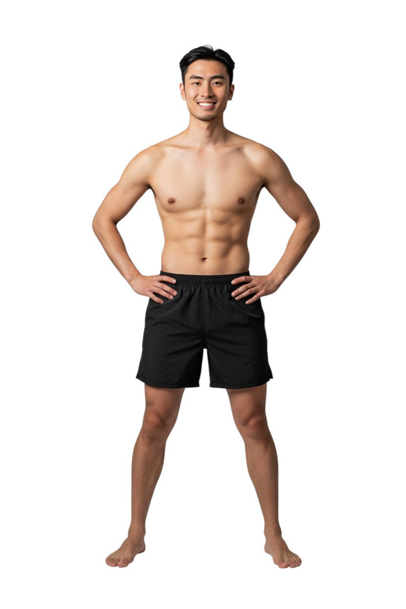 The Lifeguard Store Kiefer 4-Way Unisex Deck Short in black, featuring an elastic waist, side pockets, and a back pocket with velcro closure.