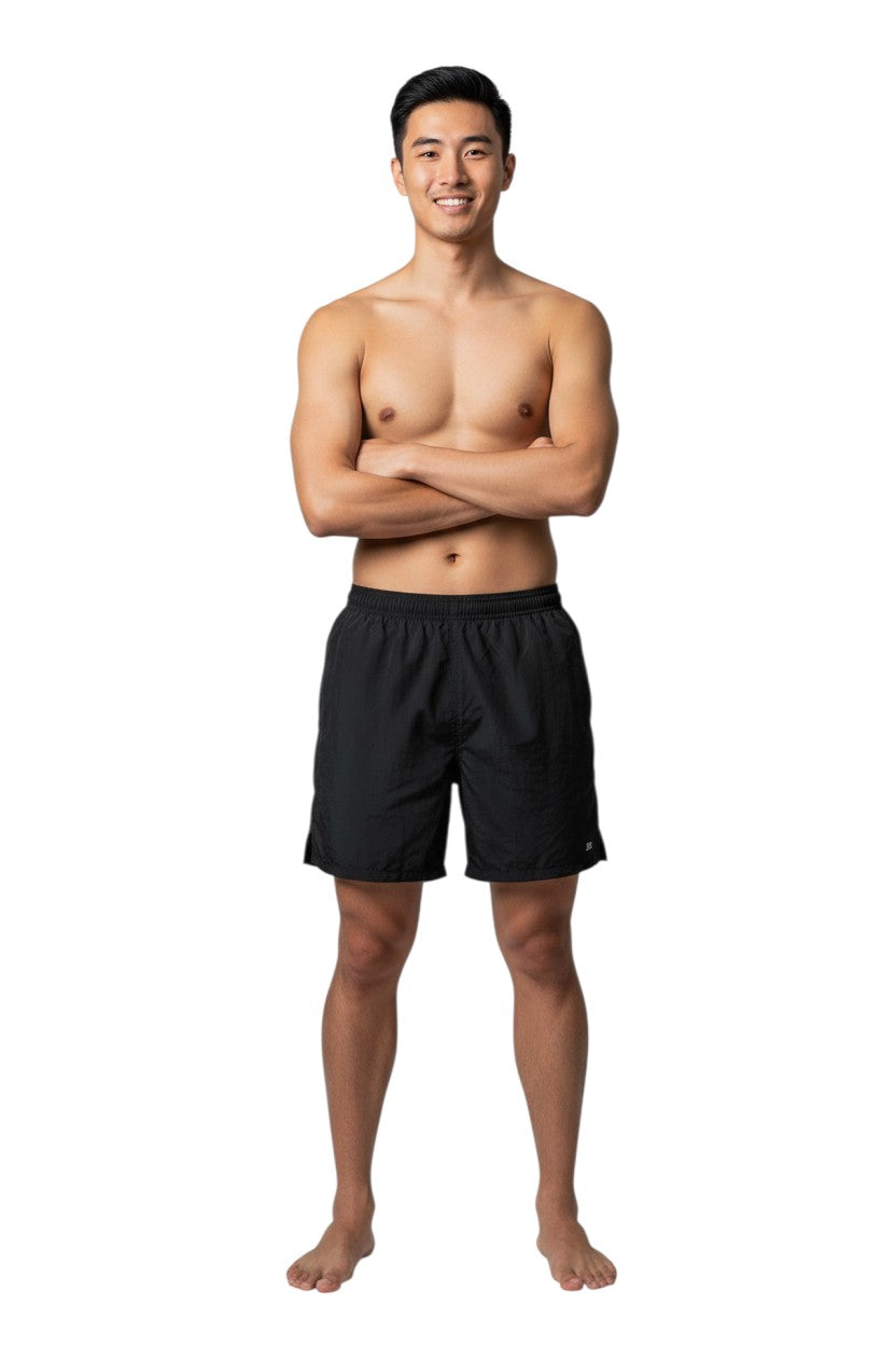 The Lifeguard Store Kiefer 4-Way Unisex Deck Short in black, featuring an elastic waist, side pockets, and a back pocket with velcro closure.