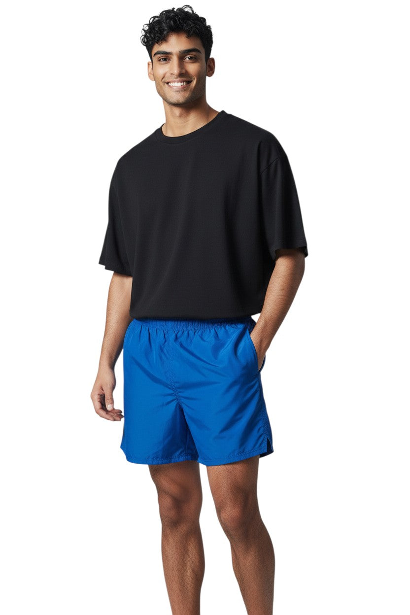 The Lifeguard Store Kiefer 4-Way Unisex Deck Short in solid blue with elastic waist, drawstring, side pockets, and velcro back pocket.