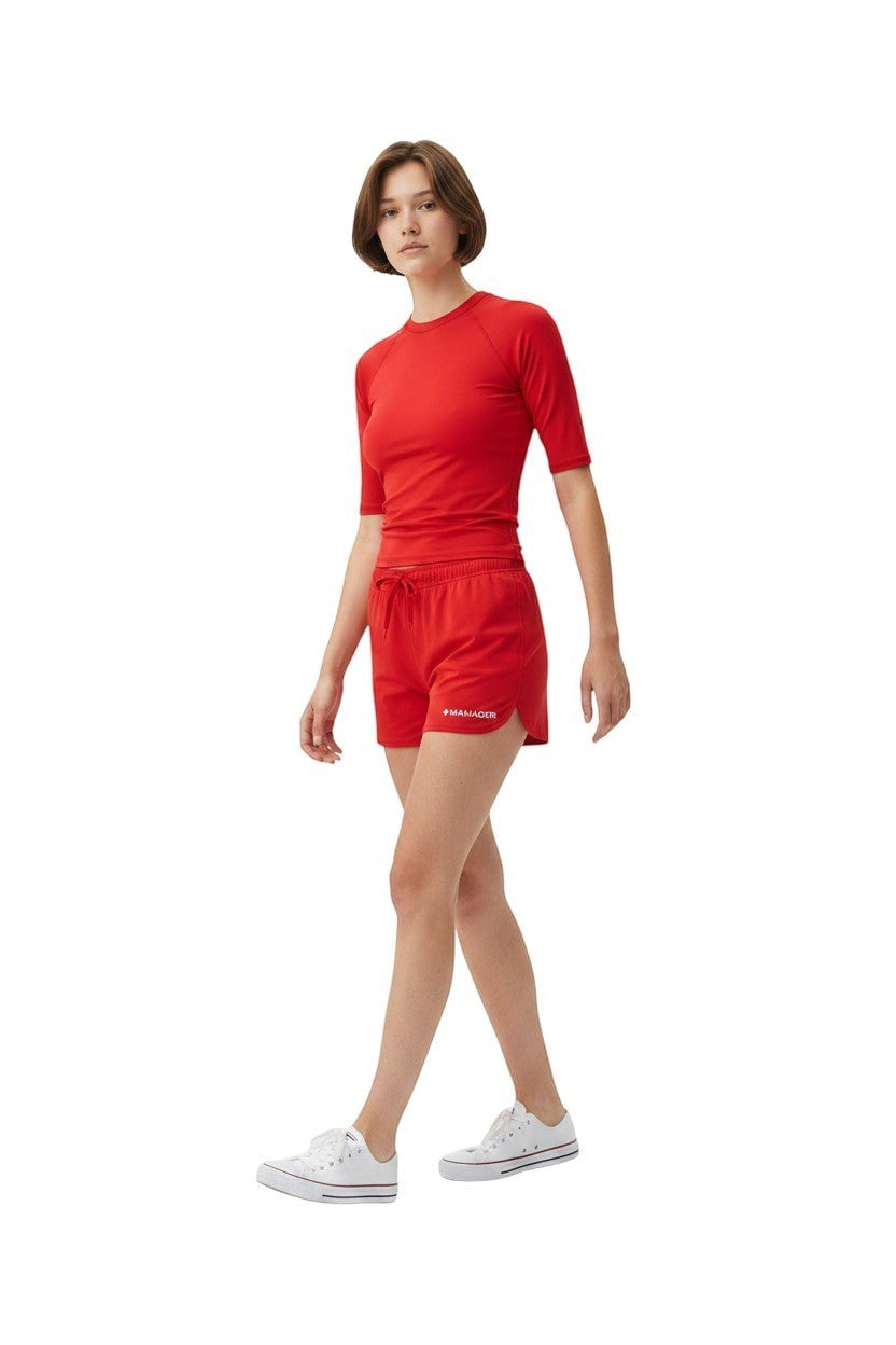 The Lifeguard Store Kiefer Manager Women's red polyester 5" shorts with drawstring and white text detail.