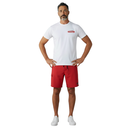 The Lifeguard Store white cotton Manager Tee worn by a man with red shorts, featuring a red manager logo on the chest.