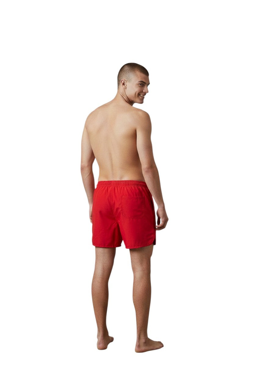 The Lifeguard Store Men's red 5" swim shorts with elastic waistband, drawstring, and side pockets. Features a white +GUARD logo.