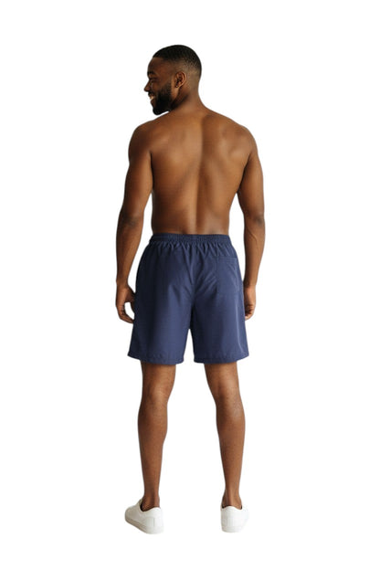 The Lifeguard Store navy blue polyester board shorts with elastic waistband and drawstring. Features UPF30+ protection.