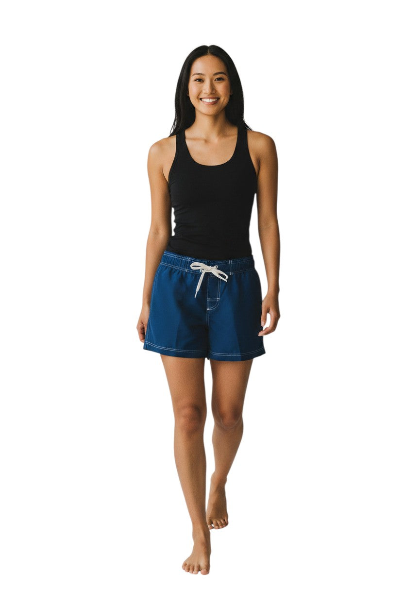 The Lifeguard Store navy blue polyester flex shorts with white drawstring and contrast stitching. Features side pocket and 5" inseam.