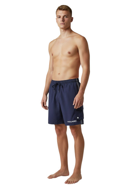 The Lifeguard Store navy blue polyester board shorts with liner, elastic waistband, drawstring, and cargo pocket. Features UPF30+ protection.