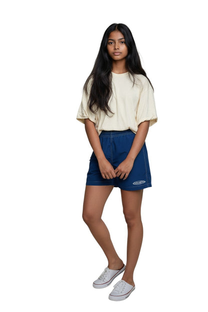 The Lifeguard Store navy blue polyester-spandex board shorts with white stitching and GUARD logo.