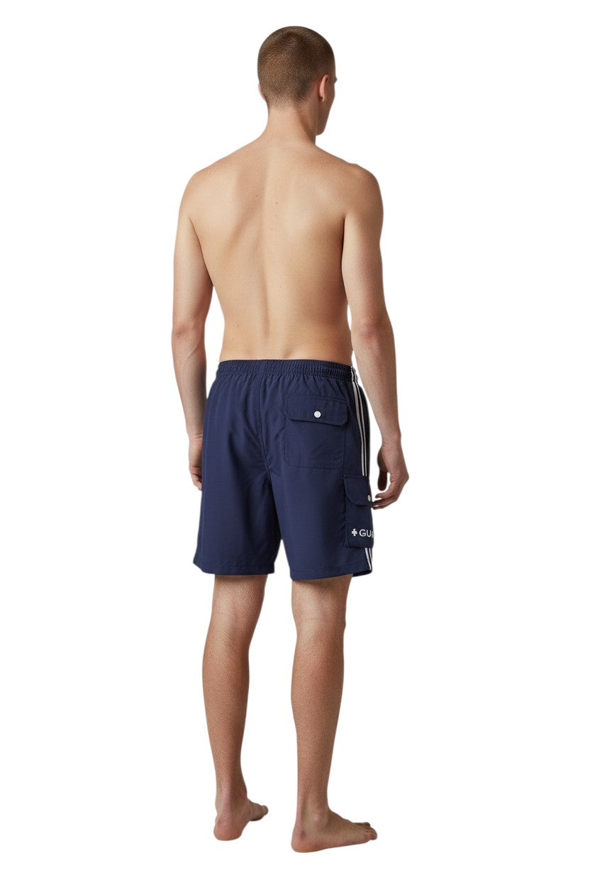 The Lifeguard Store navy blue polyester board shorts with liner, elastic waistband, drawstring, and cargo pocket. Features UPF30+ protection.