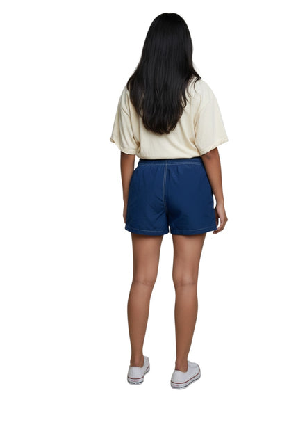 The Lifeguard Store navy blue polyester-spandex board shorts with elastic drawstring waist and side pocket. Features GUARD logo.