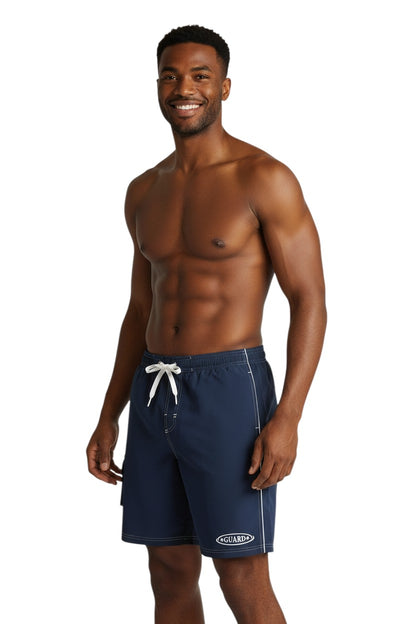 The Lifeguard Store navy blue polyester-spandex boardshorts with white drawstring, contrast piping, and GUARD logo.