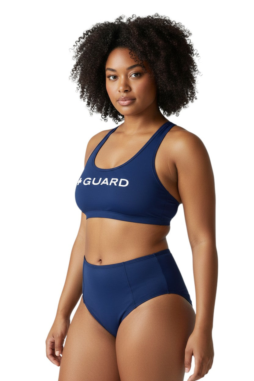The Lifeguard Store navy blue polyester-spandex racer back top with white "+ GUARD" graphic. UPF 50+.
