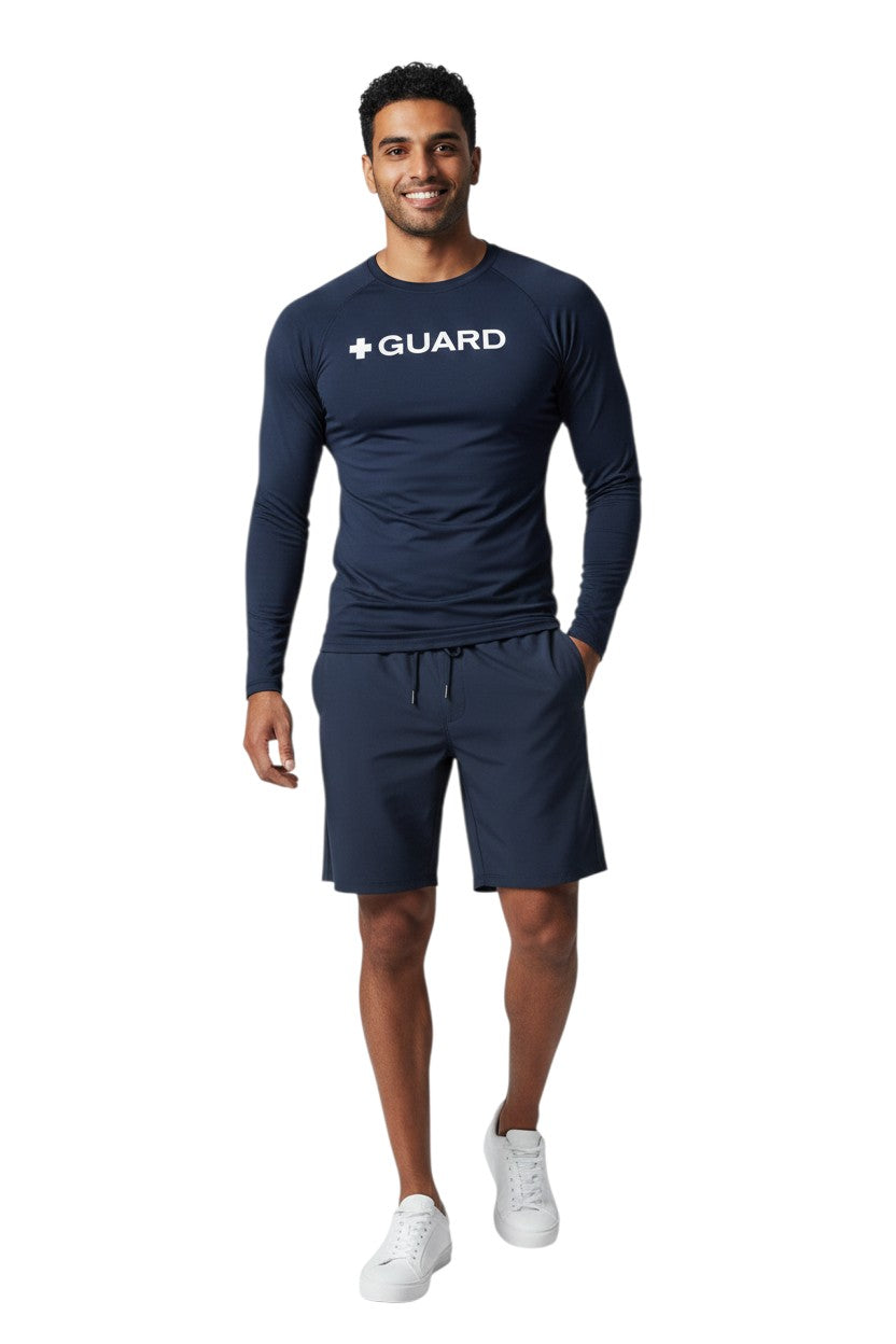 The Lifeguard Store navy blue long sleeve crewneck rashguard with white + GUARD text on chest. Polyester/spandex blend.