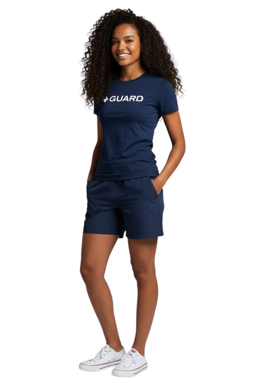 The Lifeguard Store Kiefer Guard short sleeve crewneck rashguard in navy blue polyester with white "+ GUARD" graphic. UPF50+ protection.